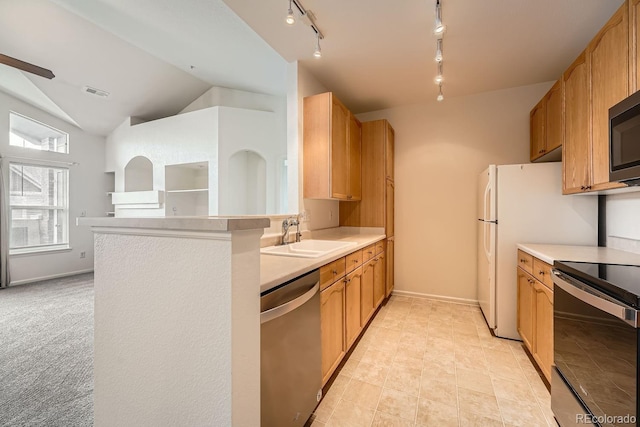 kitchen featuring visible vents, lofted ceiling, appliances with stainless steel finishes, light countertops, and a sink