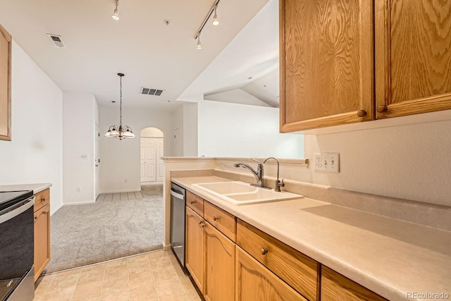 kitchen with arched walkways, a sink, visible vents, light countertops, and appliances with stainless steel finishes