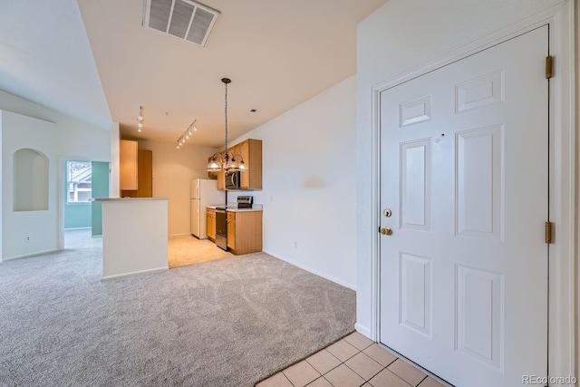 kitchen with light carpet, stainless steel appliances, visible vents, light countertops, and an inviting chandelier