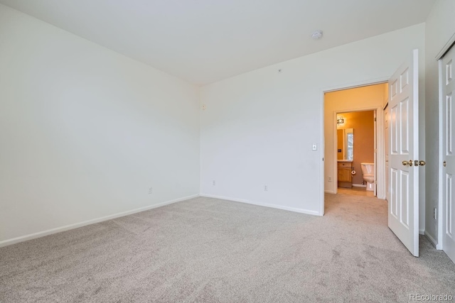 empty room with baseboards and light colored carpet