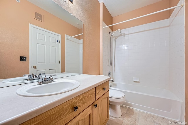 bathroom featuring visible vents, toilet, tile patterned floors, bathtub / shower combination, and vanity