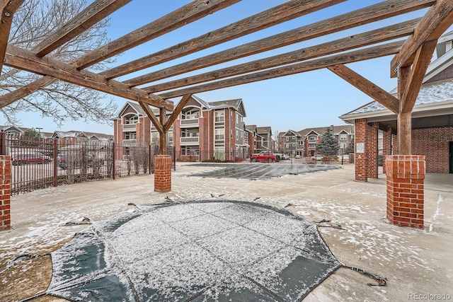 view of patio featuring fence, a residential view, and a pergola