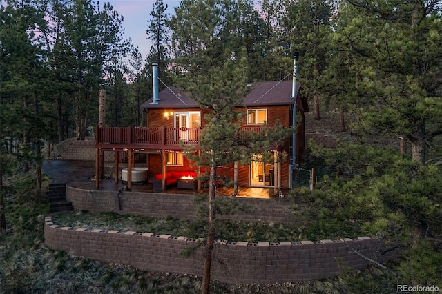 rear view of house with an outdoor hangout area, a patio area, and a deck