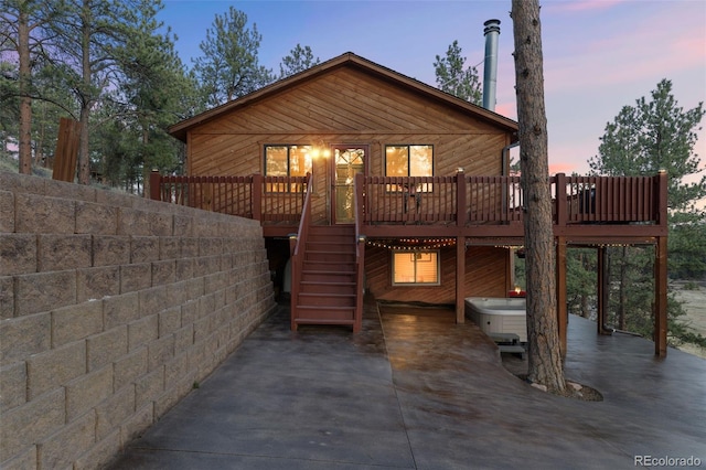 view of front of home with a deck and stairway