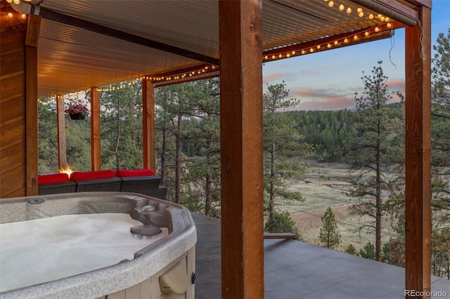 31214 Evans View Ln, Pine, CO 80470 - view of patio / terrace featuring a hot tub and a wooded view