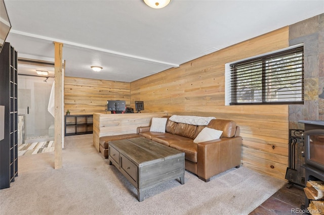 living room with wooden walls and a wood stove