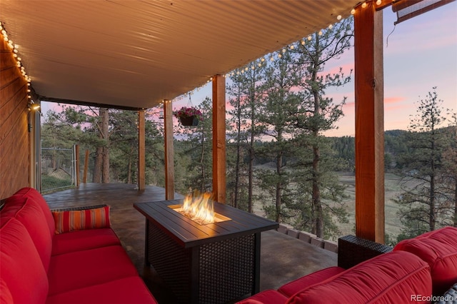 31214 Evans View Ln, Pine, CO 80470 - deck at dusk with an outdoor living space with a fire pit and a patio