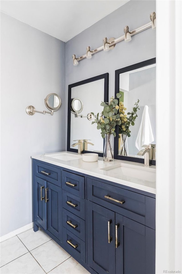 bathroom with tile patterned flooring, double vanity, and a sink