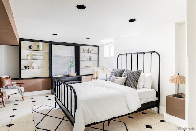 bedroom featuring light tile patterned flooring and baseboards