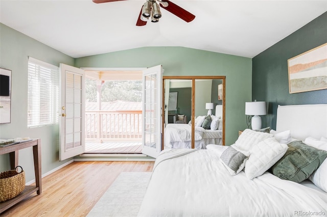 bedroom featuring baseboards, vaulted ceiling, wood finished floors, a ceiling fan, and access to outside