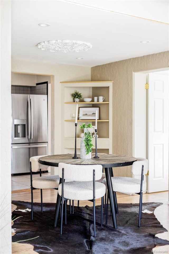 dining space with wood finished floors