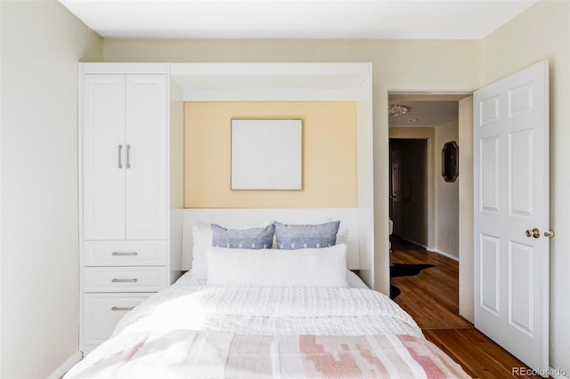 bedroom with dark wood finished floors