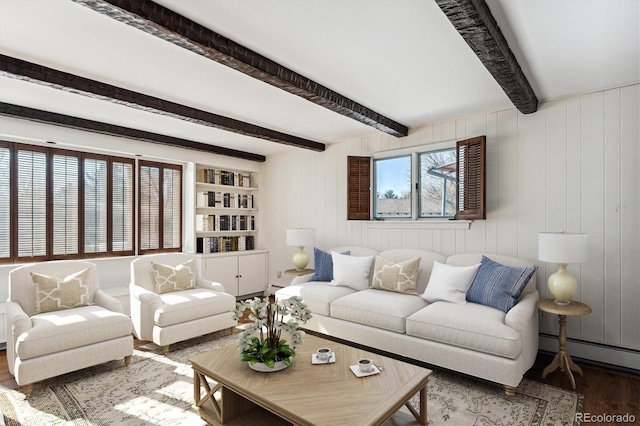 living room with wood walls, beamed ceiling, hardwood / wood-style floors, and a baseboard radiator