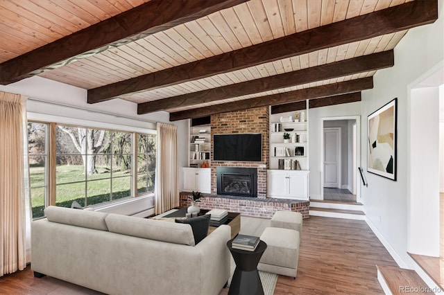 living room with beamed ceiling, wooden ceiling, wood-type flooring, and a brick fireplace