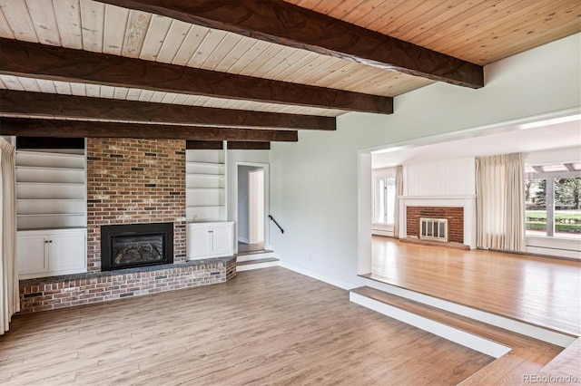 unfurnished living room featuring wood ceiling, a brick fireplace, hardwood / wood-style floors, beam ceiling, and built in shelves