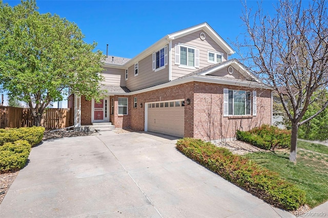 24285 E Wagon Trail Ave, Aurora, CO 80016 - view of front facade featuring a garage, brick siding, and concrete driveway
