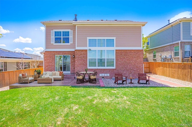 24285 E Wagon Trail Ave, Aurora, CO 80016 - rear view of house featuring an outdoor living space, brick siding, and a patio