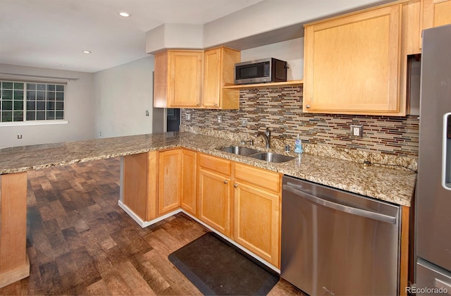 980 Lakepoint Dr Unit 1, Frisco, CO 80443 - kitchen featuring stainless steel appliances, dark wood finished floors, a peninsula, light stone countertops, and backsplash