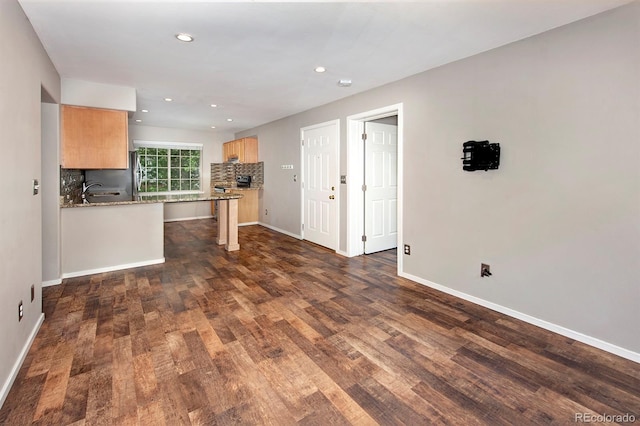 980 Lakepoint Dr Unit 1, Frisco, CO 80443 - kitchen featuring a fireplace, light brown cabinets, dark wood-style floors, recessed lighting, and decorative backsplash