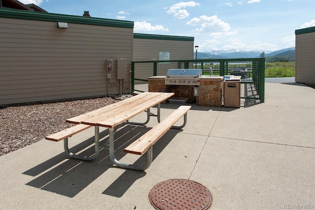 980 Lakepoint Dr Unit 1, Frisco, CO 80443 - view of patio with exterior kitchen and a mountain view