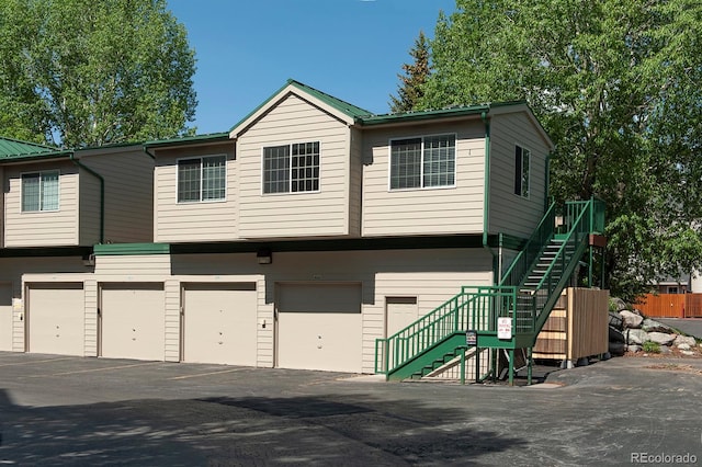 980 Lakepoint Dr Unit 1, Frisco, CO 80443 - townhome / multi-family property with a garage, stairs, and asphalt driveway