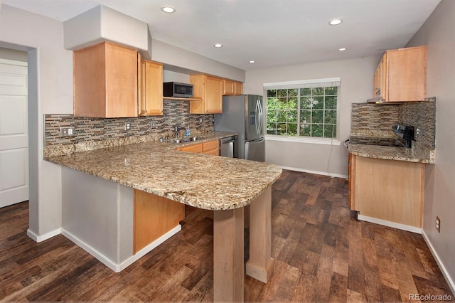 980 Lakepoint Dr Unit 1, Frisco, CO 80443 - kitchen with appliances with stainless steel finishes, light brown cabinetry, light stone countertops, decorative backsplash, and recessed lighting