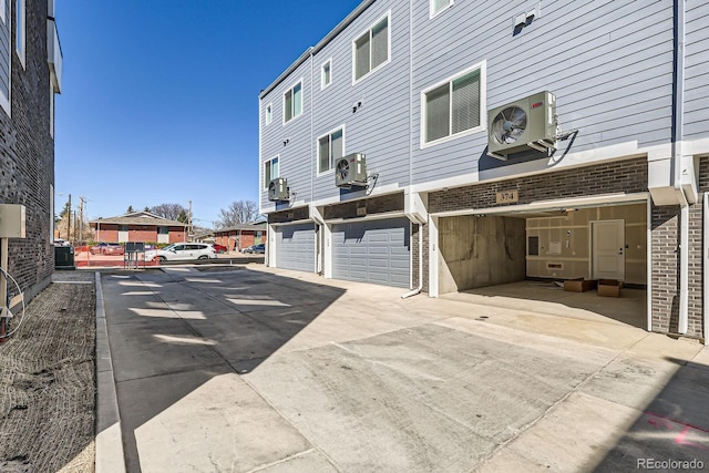 374 N Geneva, Aurora, CO 80010 - back of house with a cooling unit, an attached garage, driveway, and brick siding