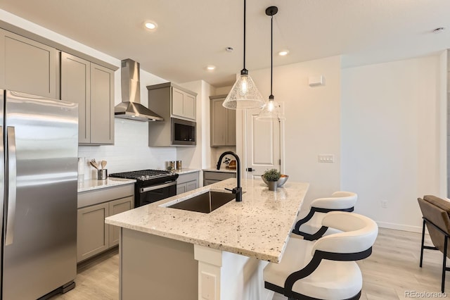 374 N Geneva, Aurora, CO 80010 - kitchen featuring stainless steel appliances, gray cabinetry, wall chimney range hood, a sink, and recessed lighting