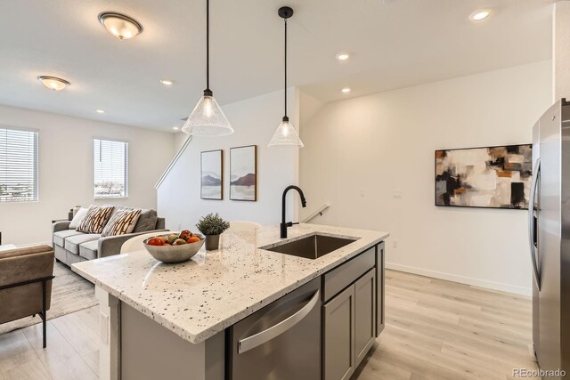 374 N Geneva, Aurora, CO 80010 - kitchen featuring appliances with stainless steel finishes, a sink, light wood-style floors, open floor plan, and gray cabinetry