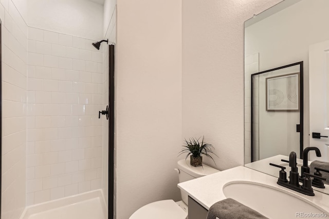 374 N Geneva, Aurora, CO 80010 - full bathroom featuring vanity, toilet, and tiled shower