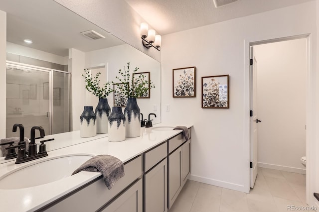 374 N Geneva, Aurora, CO 80010 - full bath with double vanity, a shower stall, toilet, baseboards, and tile patterned flooring