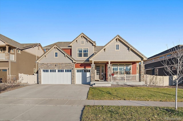 315 Painted Horse Way, Erie, CO 80516 - craftsman-style home featuring covered porch, stone siding, driveway, and an attached garage