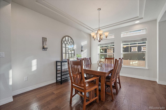315 Painted Horse Way, Erie, CO 80516 - dining room with dark wood finished floors, a tray ceiling, a chandelier, and baseboards