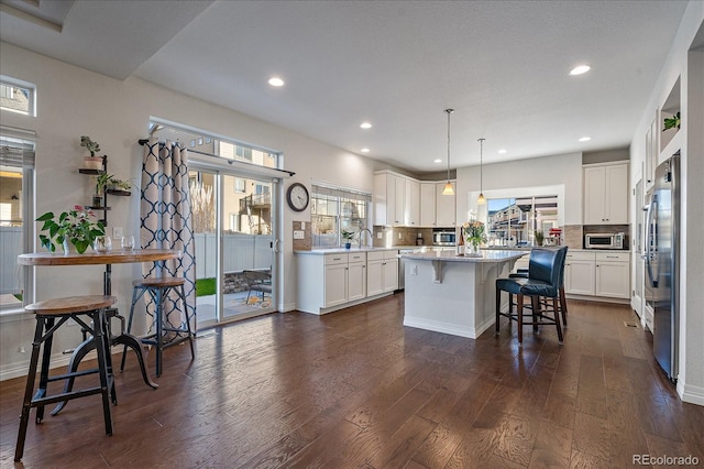 315 Painted Horse Way, Erie, CO 80516 - kitchen featuring a center island, dark wood-style flooring, a sink, white cabinets, and recessed lighting