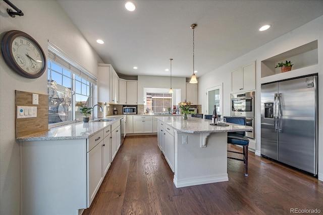 315 Painted Horse Way, Erie, CO 80516 - kitchen featuring stainless steel appliances, open shelves, white cabinetry, a kitchen island, and dark wood finished floors