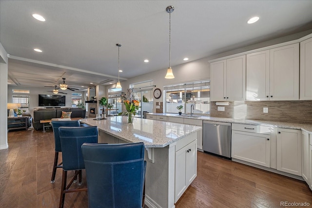 315 Painted Horse Way, Erie, CO 80516 - kitchen with stainless steel dishwasher, plenty of natural light, ceiling fan, white cabinetry, and recessed lighting