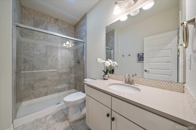 315 Painted Horse Way, Erie, CO 80516 - bathroom with toilet, vanity, a stall shower, and tile patterned flooring