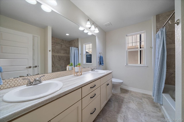 315 Painted Horse Way, Erie, CO 80516 - bathroom featuring double vanity, healthy amount of natural light, toilet, and baseboards