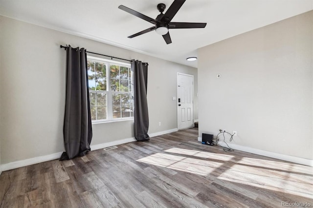 unfurnished room with ceiling fan and wood-type flooring