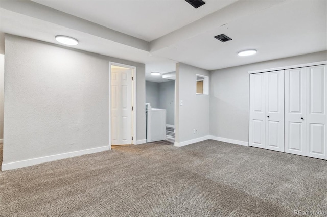 unfurnished bedroom with washer / clothes dryer, a closet, and carpet