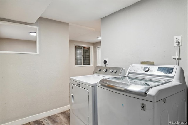 clothes washing area featuring separate washer and dryer and light wood-type flooring