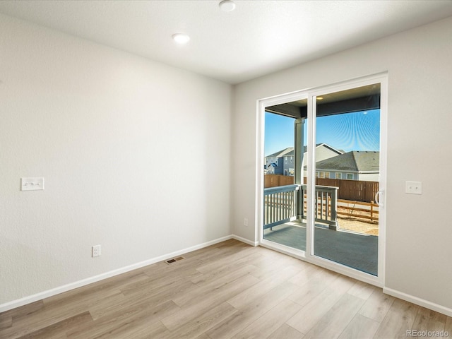 spare room featuring light hardwood / wood-style floors