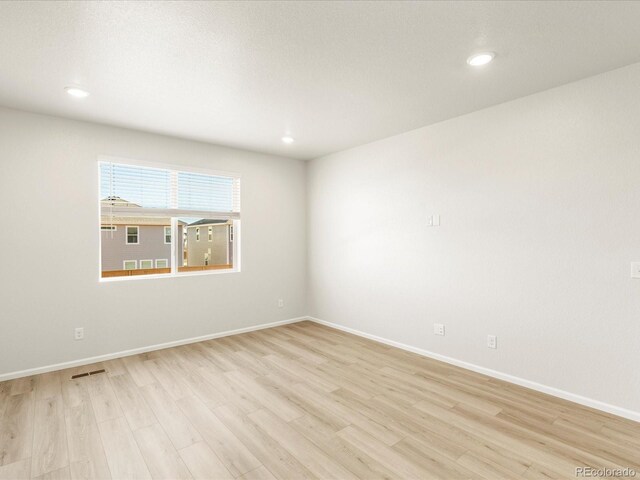 unfurnished room with light hardwood / wood-style flooring