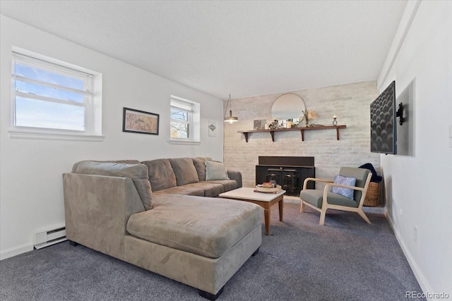 living room with baseboard heating, a fireplace with raised hearth, carpet flooring, and baseboards
