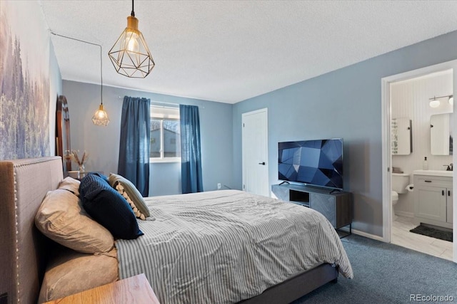bedroom with carpet and ensuite bathroom