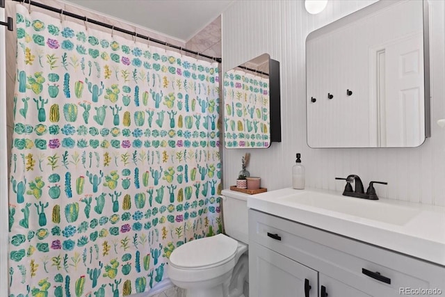 bathroom featuring toilet, vanity, and a shower with curtain