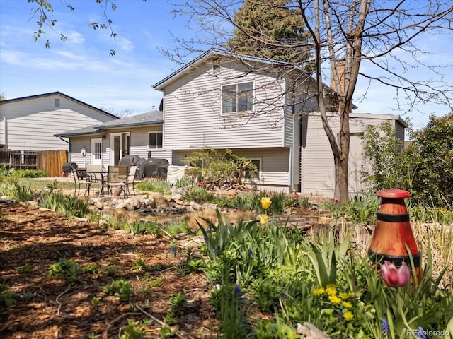 back of property featuring fence and a patio area