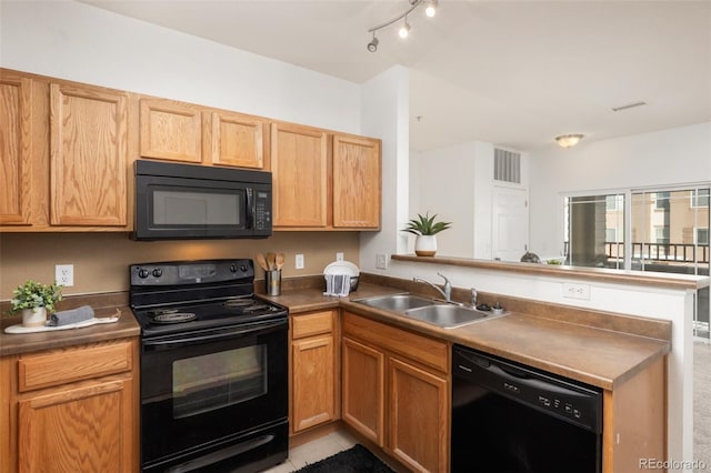 kitchen with black appliances, kitchen peninsula, sink, and light tile patterned floors