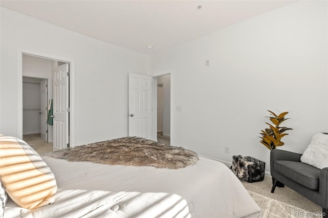 bedroom with light colored carpet and connected bathroom