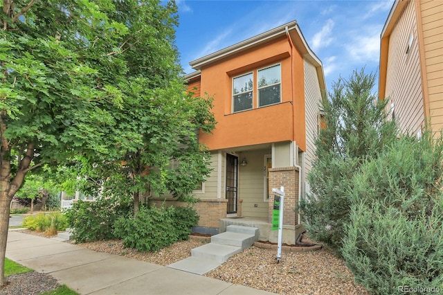 8458 Parkland St, Broomfield, CO 80021 - view of front of house featuring brick siding and stucco siding